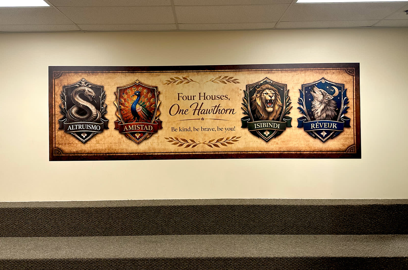 Four Houses, One Hawthorn identity mural at Hawthorn Academy, four custom house crests above the main stairwell